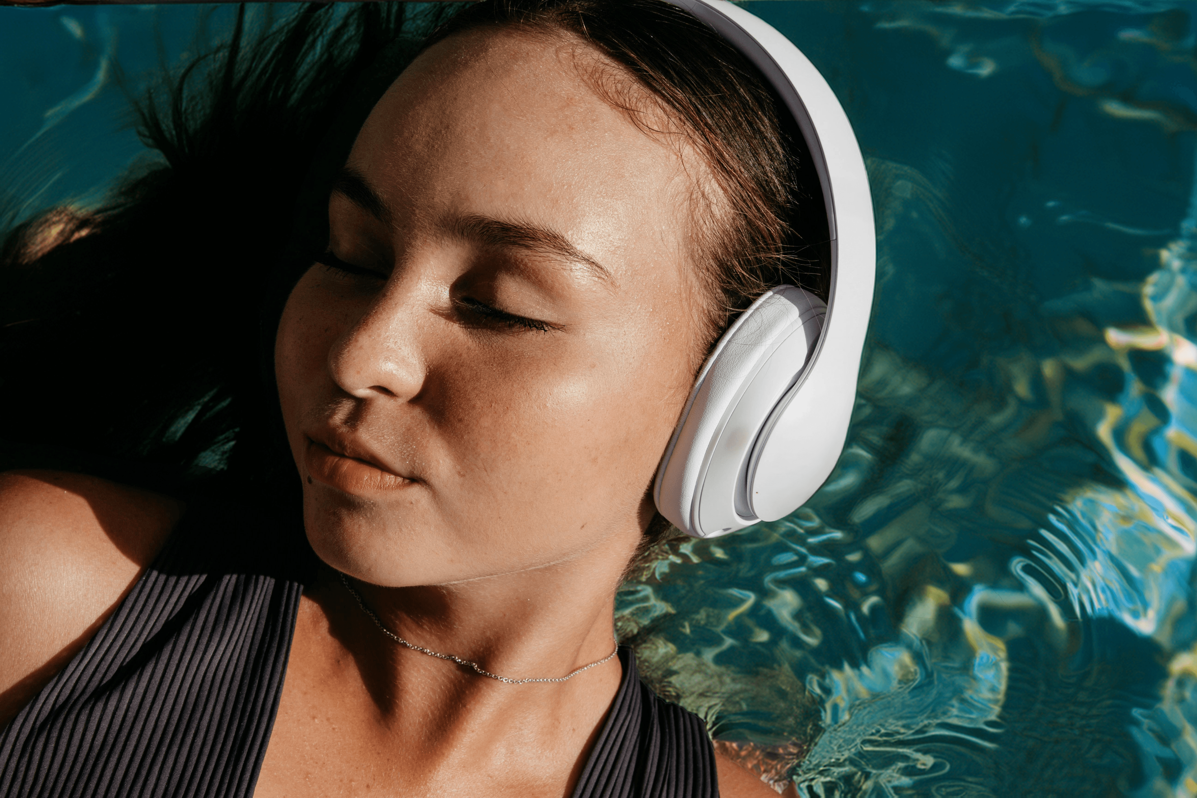 Woman with headphones by water
